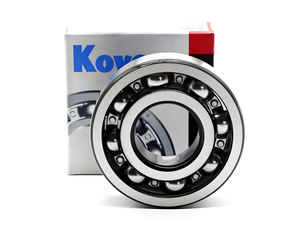 Vòng bi Koyo: Vòng bi cầu hở đặt trước hộp Koyo xanh
