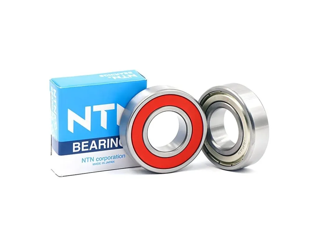 Vòng bi NTN: Hai vòng bi nắp cao su đỏ và nắp sắt cạnh hộp NTN